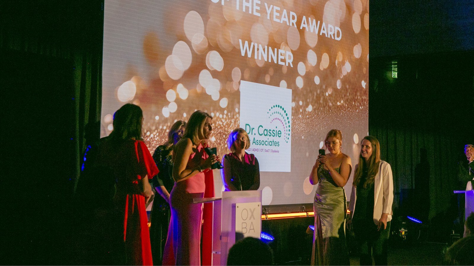 Dr Cassie & Associates team on stage receiving the SME of the Year Award
